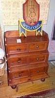 Front view of the handcrafted primitive pine step chest showing three drawers and the wooden welcome sign on top.