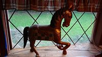 Front view of the hand carved wooden horse showing paint finish and pegged parts