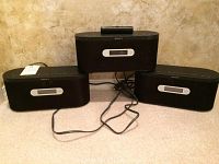 Three Sony AIR-SA15R wireless speakers with transmitter and cords on carpet.
