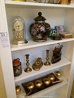 Shelf with anniversary clock, hand painted Chinese pot, small dishes and coasters.