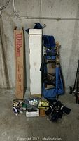 Full view of the set showing golf carry bag, boxed golf clubs, various golf ball boxes, and accessories arranged on floor