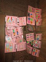 Two boxes filled with various kids party bag toys mounted on pink 'Party Fun' cards.