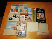 Complete overview photo of all sewing machine accessories including boxes, parts and book.