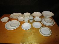 Overview of all vintage and retro Corelle dishes showing plates, bowls, mugs in different floral border colors.