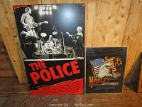 Two framed posters, one large The Police concert poster and one smaller Harley Davidson motorcycle poster with eagle and American flag.