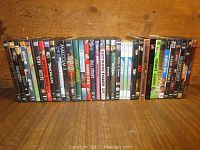 36 DVDs and 1 Blu-ray displayed in a row, showing various movie titles and cover arts.