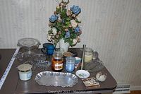 Full lot of vintage Candlewick glass pieces, various scented candles, silver-tone tray, and Lenox porcelain vase with faux flowers on table surface.