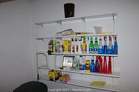 Wide view of shelving with various cleaning products including spray bottles and containers