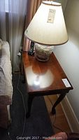 Overall side table from above with lamp on top showing top and part of side and legs