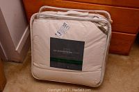 Full view of the Gluckstein Home duvet in clear zippered package, showing branding and packaging condition