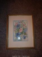 Framed watercolor painting showing overall frontal view of floral scene in gold-tone frame