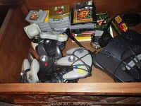 Drawer with multiple controllers and stacked game cartridges