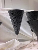 Close-up of black animal print champagne flute with clear stem.