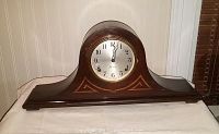 Full view of the antique Sessions mantle clock showing wooden inlaid case and clock face.