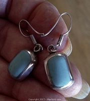Close-up of front of turquoise and sterling silver earrings
