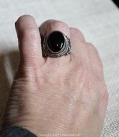 The ring worn on a finger, showing size fit and overall appearance.
