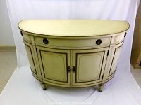 Front view of the demi lune hall console desk showing the half-moon shape, cream paint finish, decorative trim, and round drawer pulls.