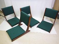 Four vintage Japanese Zaisu wood framed floor chairs with green upholstery displayed in seated position.