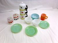 Full display of glass and dishware showing various mugs including Fire King and Federal jadeite plates, Siesta Ware cups, and other vintage items.