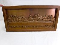 Full view of the rectangular copper-toned relief wall hanging framed in brown plastic, showing The Last Supper scene with Jesus Christ and his disciples seated at a long table.