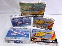 Five Matchbox model kits featuring helicopters and planes on original boxes, some sealed.