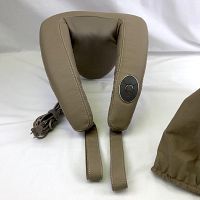 Brookstone neck massager showing wraparound padded design, control buttons on arm, and attached power cord.