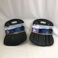 Two black ObusForme Back Boost Comfort seats side by side with cardboard packaging still attached.