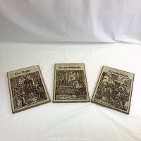 Three ceramic tiles arranged side by side showing the full artwork and titles.