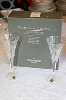 Two Waterford crystal flute glasses with The Millennium Collection box in the background.