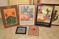 Five framed children's wall art prints arranged on floor including 'Good Morning' and 'Good Night' prints and three smaller animal and garden scene prints