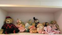 Shelf showing seven Muffy Vanderbear collectible bears in various themed outfits.