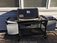 Front and side views of the Weber Silver Genesis gas grill showing lid, side burner, trash bin, bottom shelf with hose and wheels.