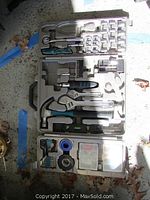 Photo of the Sharper Image tool kit open in the plastic carrying case, showing various hand tools, partially empty compartments and fasteners.