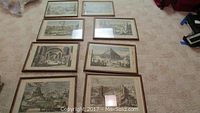 All eight framed prints laid out on carpeted floor