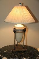 Overall view of lamp lit on marble-top table
