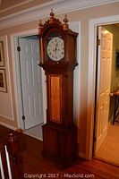 Full height view of tall case clock showing overall structure and finish