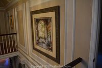 Large Italian-inspired framed print hanging on the wall showing stone archway and garden with plants and vines.