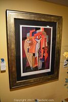 Frontal view of abstract geometric print in gold frame