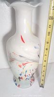 Photo of a white hand blown glass vase with multicolor speckles and measurement tape showing it is about 14 inches tall