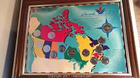 Framed set showing colorful Canadian map and coins located by province/territory.