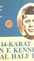 Small 14-karat gold coin featuring John F. Kennedy's face and textual details on blue display background.
