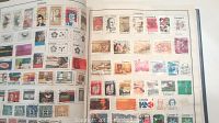 Open pages of stamp album showing numerous Canadian stamps in various denominations and designs, many featuring portraits and historical images.