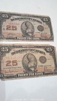 Photo of front side of two 1923 Dominion of Canada 25 cent banknotes showing design, serial numbers, and condition.