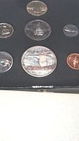 Set of seven Canadian coins from 1967 Centennial, showing silver dollar, 50 cent, 25 cent, 10 cent, 5 cent, penny, and nickel.