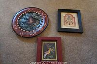 Overall view of all three items: framed Scherenschnitte art, wooden decorative plate, and framed folk art print.
