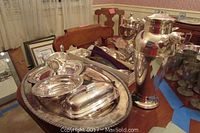 Oval tray with butter dishes, bowl and gravy boat arranged on table