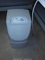 Front view of white Roper dehumidifier showing control knob dial and air vents.