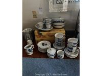 Full shot of Pfaltzgraff dinnerware showing cups, saucers, plates, bowls, sugar, and creamer arranged on a table.