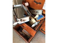 Photo of vintage German kitchen scale with stainless steel tray and ruler measurement scale on side, placed on an oak cabinet drawer with other kitchen decor visible inside.