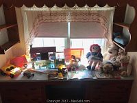Photo of collection arranged on wooden desk with window backdrop